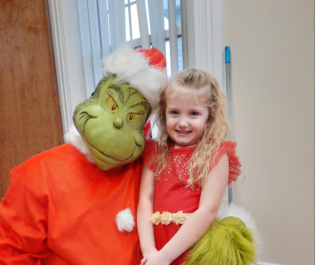 Santa Claus and The Grinch Welcome Children to Share Their Wish Lists